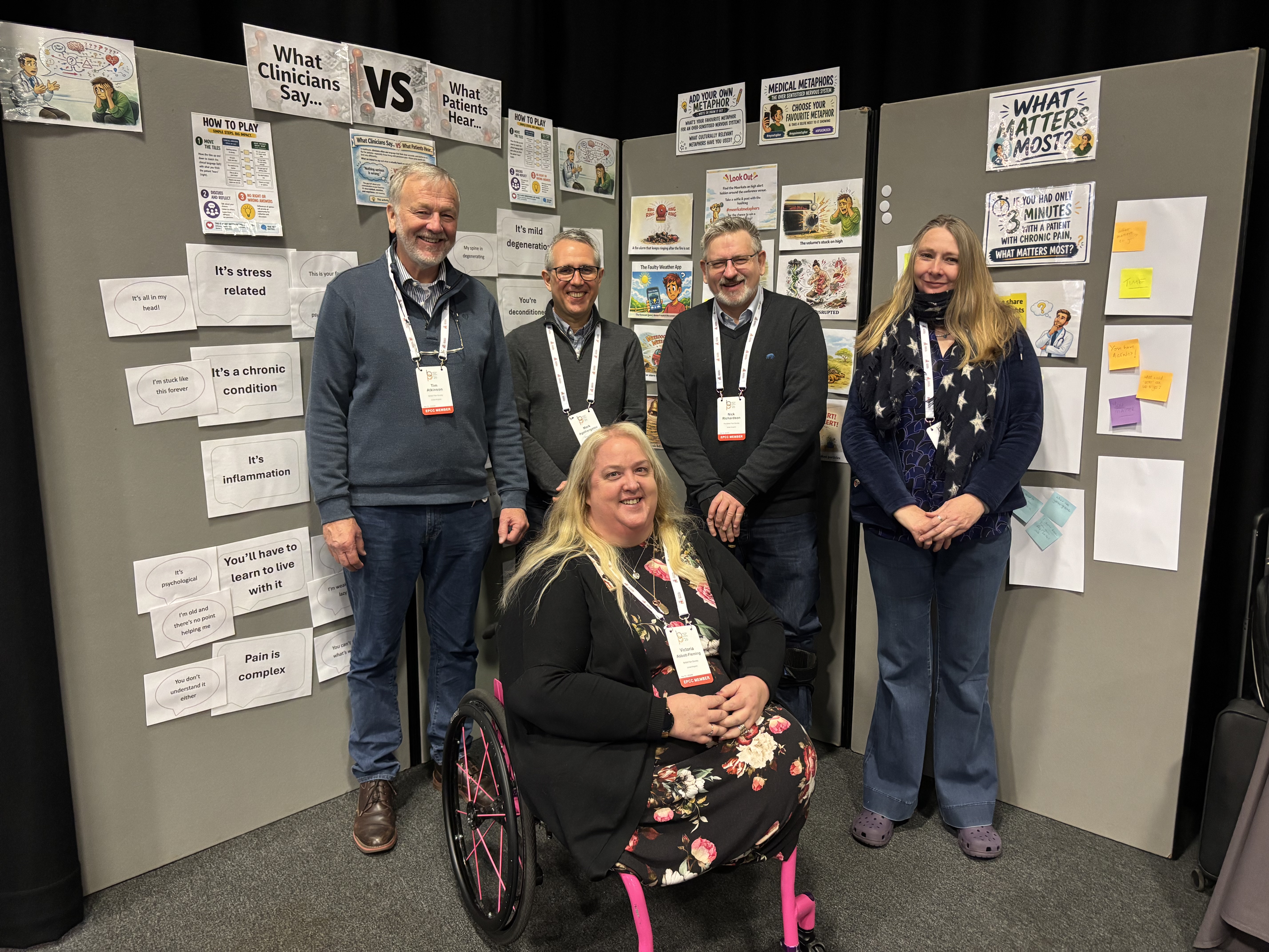 EPCC standing in front of poster boards at the conference. The poster boards show activities for delegates to get involved in